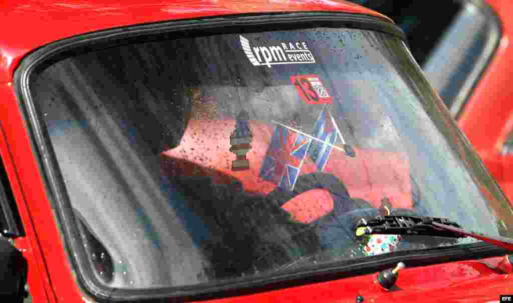 Banderas de EE UU, Cuba y Reino Unido en un auto habanero.